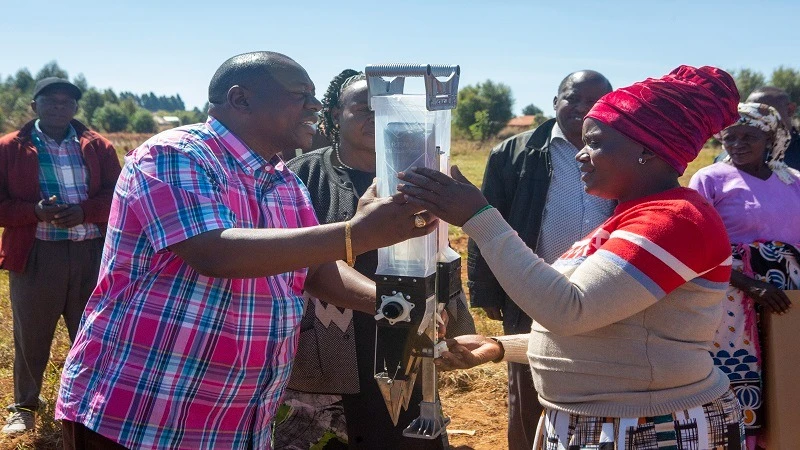 
Kilolo District Commissioner Joachim Nyingo hands over a hand planting machine (jab planter) to one of the farmers, this is among 60 machines donated by the Food and Agriculture Organization of the United Nations to help boost food production.