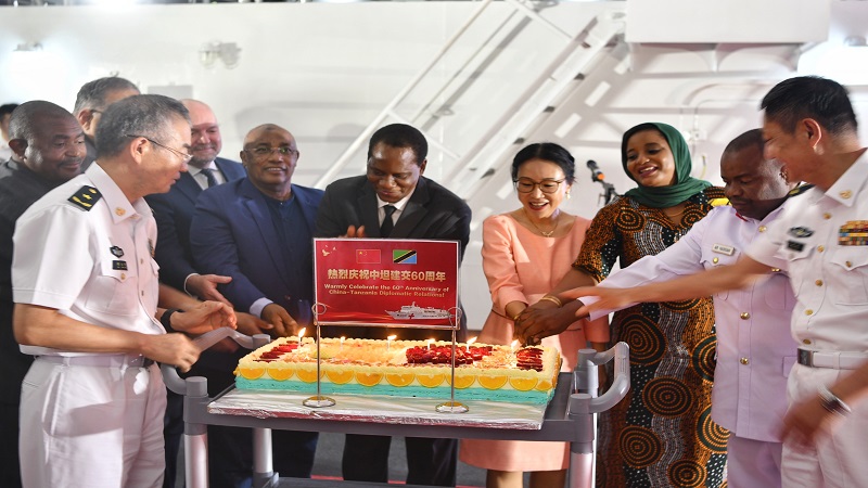 Chen Mingjian, (4 TH -R) Chinese ambassador to Tanzania, Dr Faraji Mnyepe (5 TH-R) permanent secretary in the ministry of Defense and other military officials cake cutting to mark 60 years of Tanzania-China bilateral cooperation