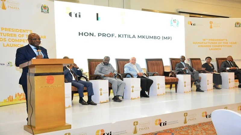 Minister for State in the President’s Office,(Planning and Investment)  Prof Kitila Mkumbo speaks during the high level industrial talk on Tanzania Vision 2025 and launch of President Manufacturer of the Year Award  (PMAYA) in Dar es Salaam yesterday. 