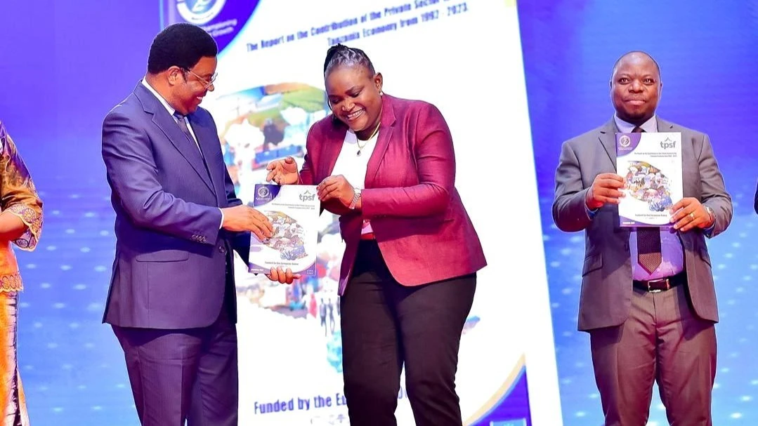 Prime Minister Kassim Majaliwa presents to Tanzania Private Sector Foundation chairperson Angelina Ngalula a copy of the 1992-2023 report on the contribution of the private sector to Tanzania’s economy shortly after launching it in Dar  on Tuesday.