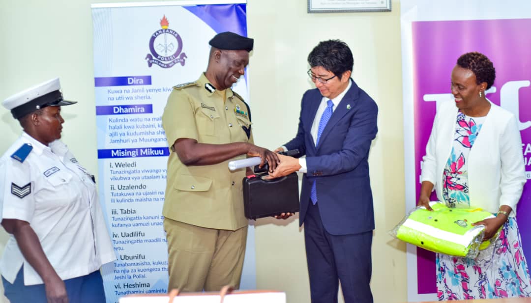 Tanzania Cigarette Public Limited Company general manager and CEO Takashi Araki gifts Dar es Salaam Special Zone Police Commander Jumanne Muliro road safety enhancement devices in Dar es Salaam yesterday 