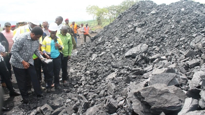 Prime Minister Kassim Majaliwa admires coal produced at Ntunduwaro village in Mbinga district.