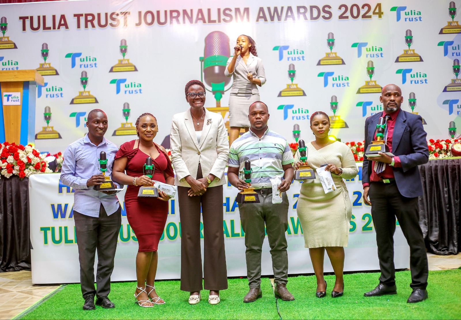 National Assembly Speaker Dr. Tulia Ackson (3rd-l) poses with IPP Media journalists who won the Tulia Trust Journalism Awards (TJA) 2024.