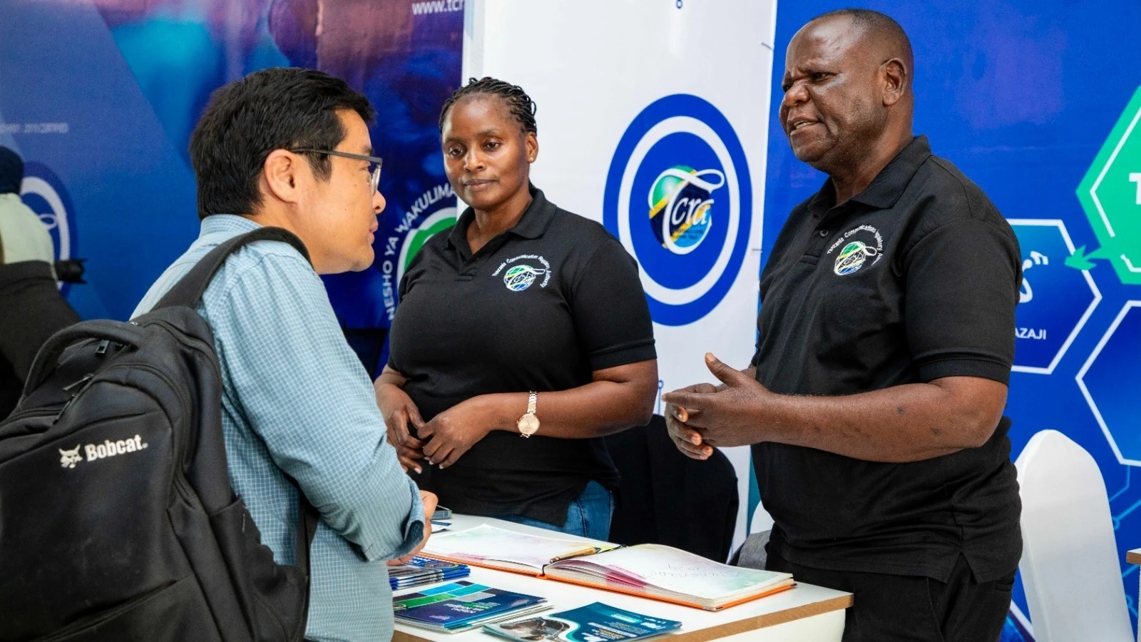 
 TCRA Officers Semu Mwakyanjala and Joyce Paul attend a Chinese national at the authority’s pavilion during the ongoing 31st Nanenane Agricultural International Expo 2024 in Dodoma yesterday.