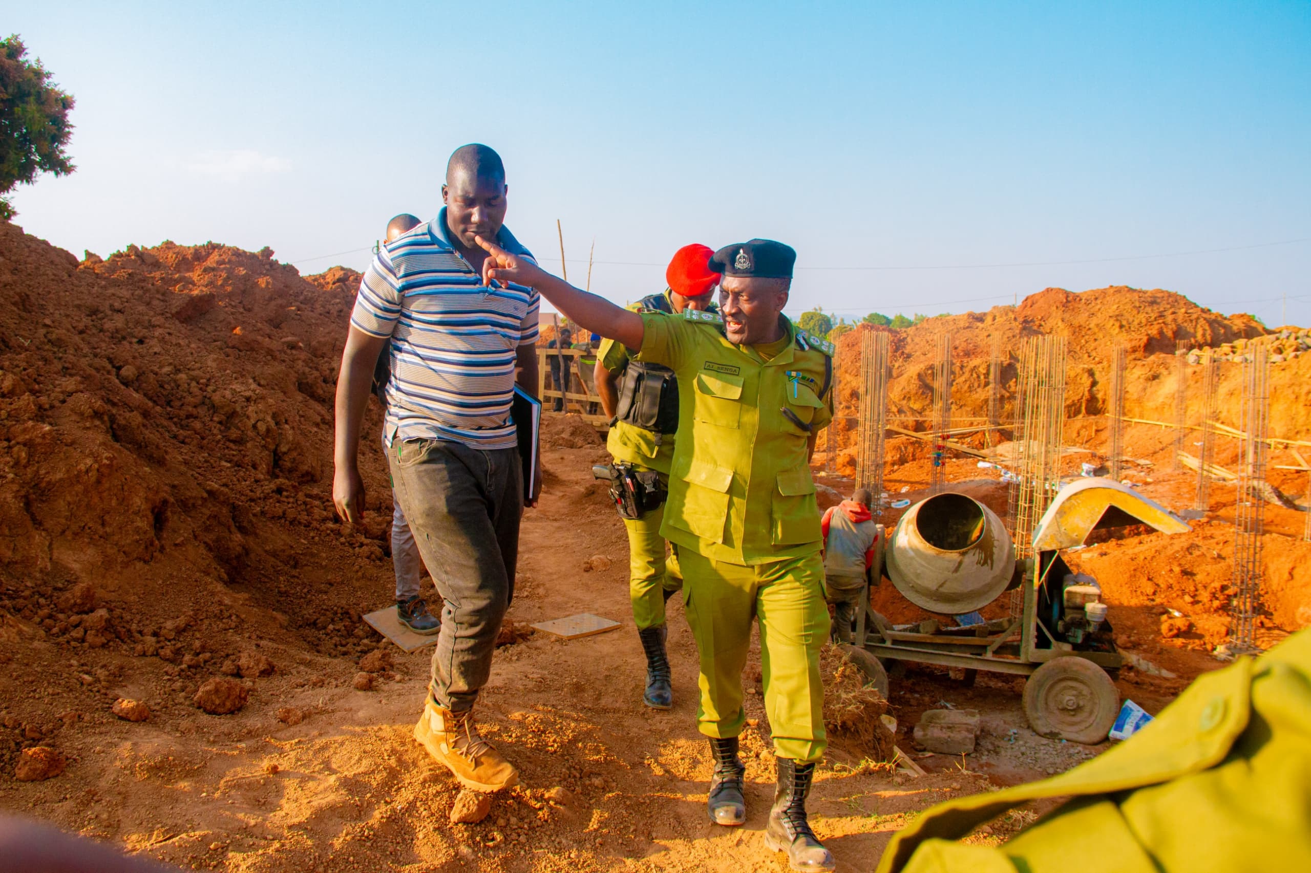 Augustino Senga, the Songwe regional police commander, inspects police post construction within gold mining area yesterday, to assess the security situation in the area. 