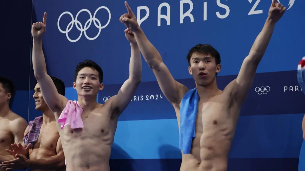 Long Daoyi (R) and Wang Zongyuan of China celebrate after the men's synchronised 3m springboard final at the Paris 2024 Olympic Games in Saint Denis, Paris, France, Aug. 2, 2024.