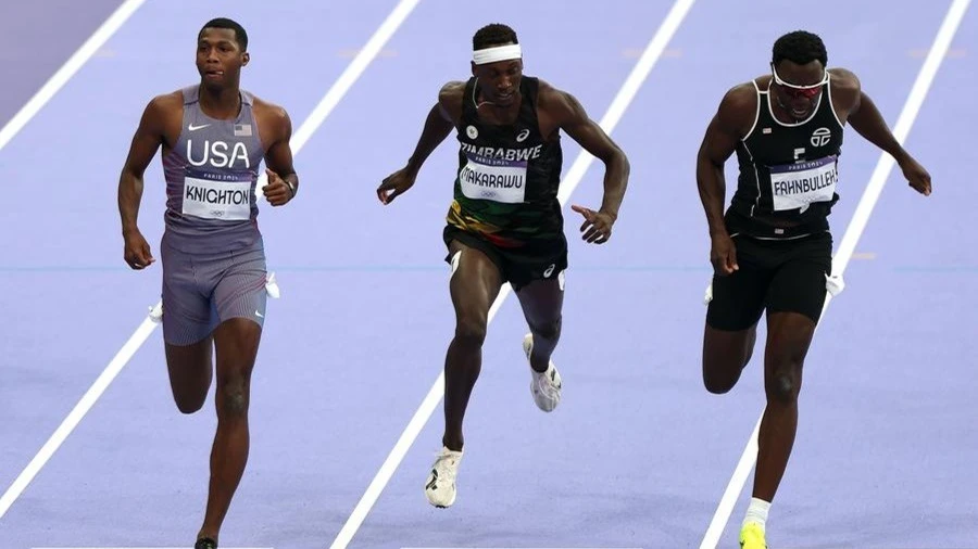 Erriyon Knighton of the United States, Tapiwanashe Makarawu of Zimbabwe, and Joseph Fahnbulleh of Liberia (from L to R) compete during the men's 200m semi-final at the Paris 2024 Olympic Games in Paris, France, Aug. 7, 2024.