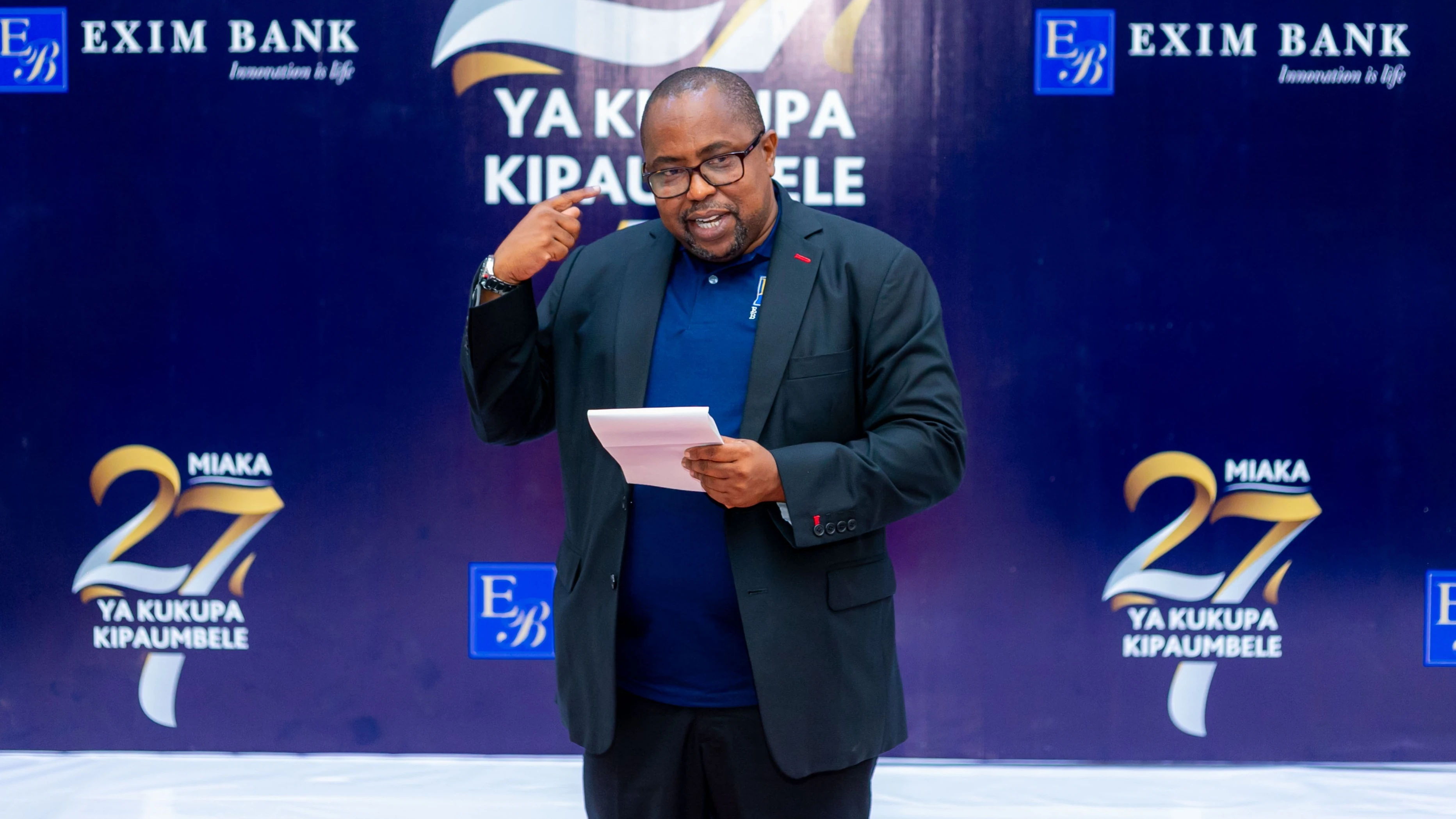 The Chief Executive Officer of Exim Bank Tanzania, Mr. Jaffari Matundu, speaking during the celebration of the bank's 27th anniversary since its establishment in 1997. The celebration, themed '27 Years of Prioritizing You,' took place.