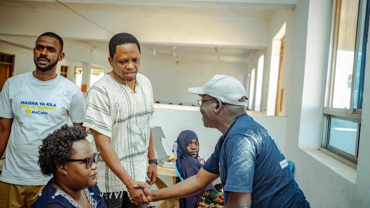 Deputy minister of arts, sports and culture and Member of Parliament, Muheza constituency Hamis Mwinjuma (C ) greets one of the elders who attended Mama Samia Eye clinic held in Muheza district.