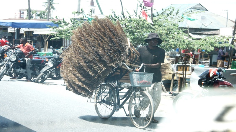 A local broom vender hunts customers at Mabibo area in  Dar es Salaam yesterday. 