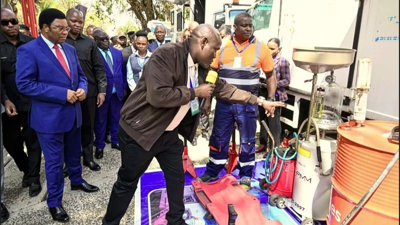 Prime Minister Kassim Majaliwa being shown working tools for motor vehicles repair at the Tanzania Electrical, Mechanical and Electronics Services Agency (TEMESA) by the technical and maintenance director Hassan Kalonda. 