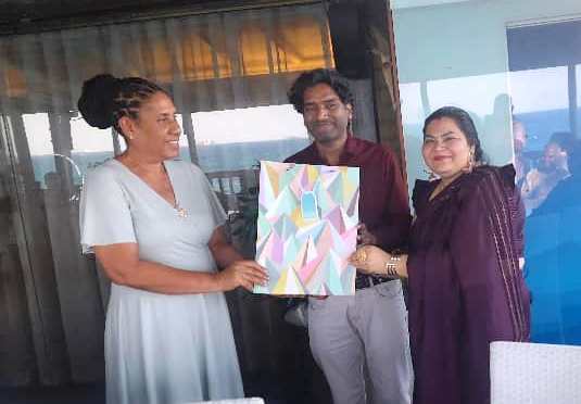 4.	Beatrice Bandawe (L), the Nipashe newspaper managing editor, presents a gift to TGL commercial director Ajay Goyal (C) and his wife