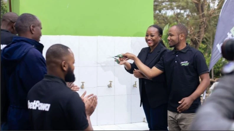 
BetPawa's East Africa Regional Marketing Manager, Borah Ndanyungu (2nd R), cuts the ribbon for the completed water project for the residents of Makiwaru Village in Siha District, Sanya Juu, Kilimanjaro region. 