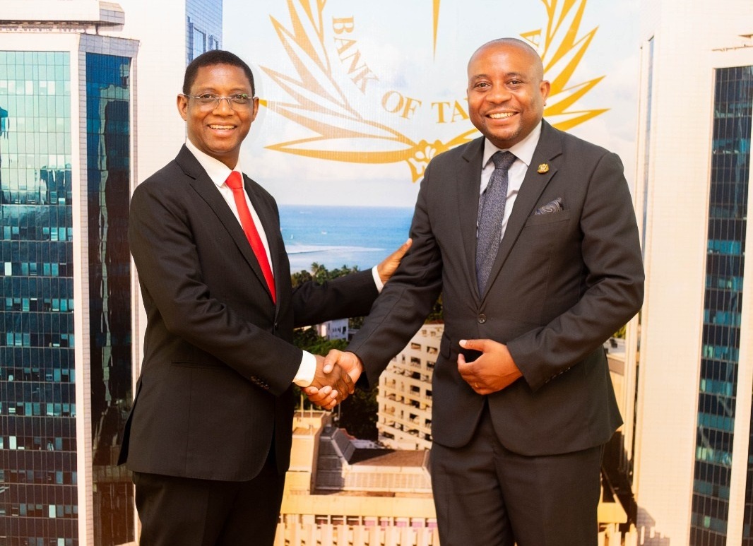 Dar es Salaam Stock Exchange CEO Peter Nalitolela (R) and Bank of Tanzania governor Emmanuel Tutuba bid each other farewell in Dar es Salaam yesterday 