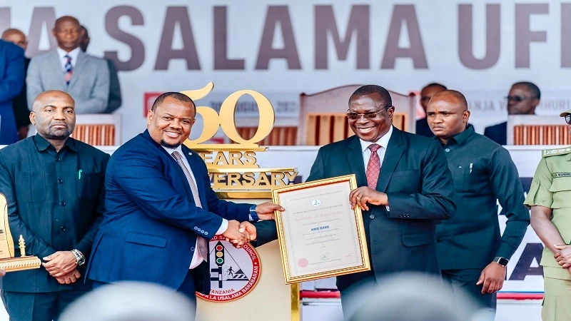 Vice President Dr. Philip Mpango, presents an award to the NMB bank’s head of Bancassurance, Martine Massawe in recognition to its contribution towards the success of the Road safety week exhibition and 50 years commemoration of the Road Safety Council