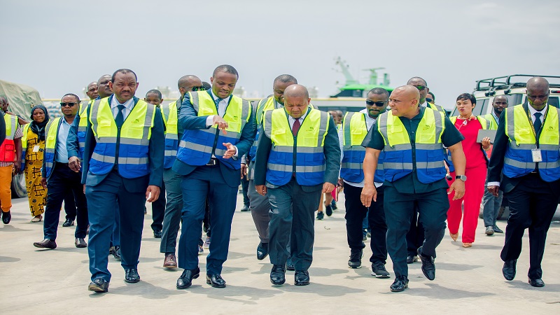 Plasduce Mbosa, the Tanzania Ports Authority (TPA) director general, in conversation with Yusuf Mwenda (third right), the Tanzania Revenue Authority (TRA) commissioner general when the two visited Tanga Port yesterday. 