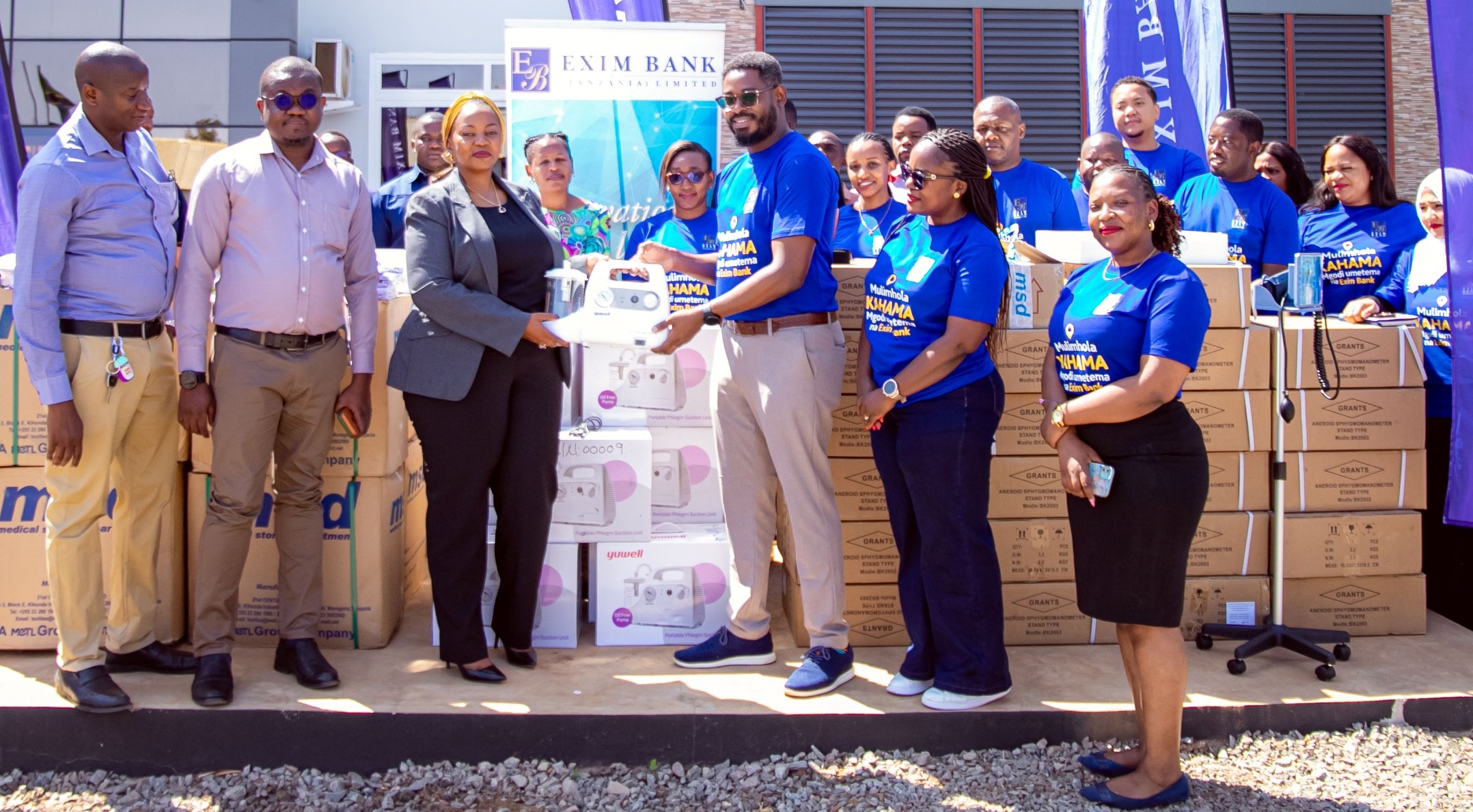 Kahama district commissioner Mboni Mhita (3rd-L) receives a donation of medical equipment and supplies from Exim Bank’s Head of Marketing and Communications, Stanley Kafu, at Kahama Municipal Hospital in Shinyanga Region on Thursday. 