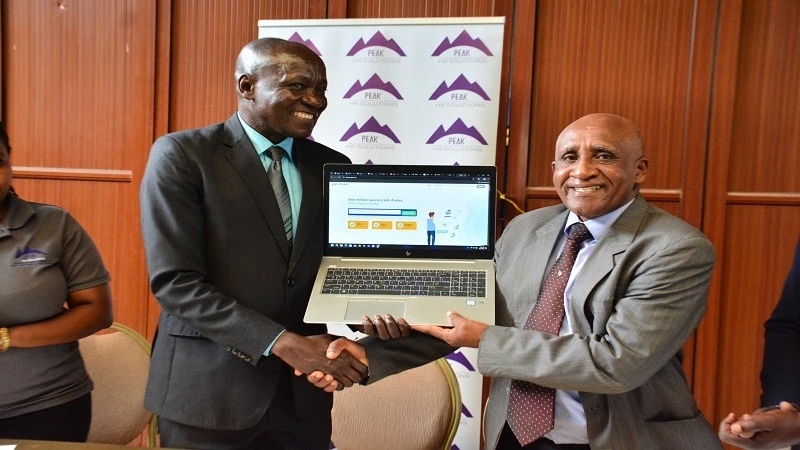 Tanzania National Business Council executive secretary Dr Godwill Wanga (L) showing Employees Reference Bureau to revolutionalise Human reources management in Tanzania.(R) Peak HR Solution managing director capt. Philemon Kisamo 