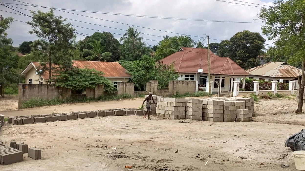 John Nkindikwa (36) laying concrete blocks at Gewe Vibrated blocks in Matosa suburb of Dar es Salaam. 