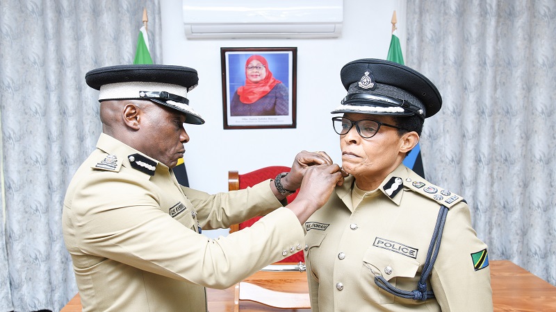 Inspector General of Police Camilius Wambura (L) confers the rank of Senior Assistant Commissioner of Police on Assistant Commissioner of Police (ACP) Dora Kiteleki in Moshi municipality yesterday.