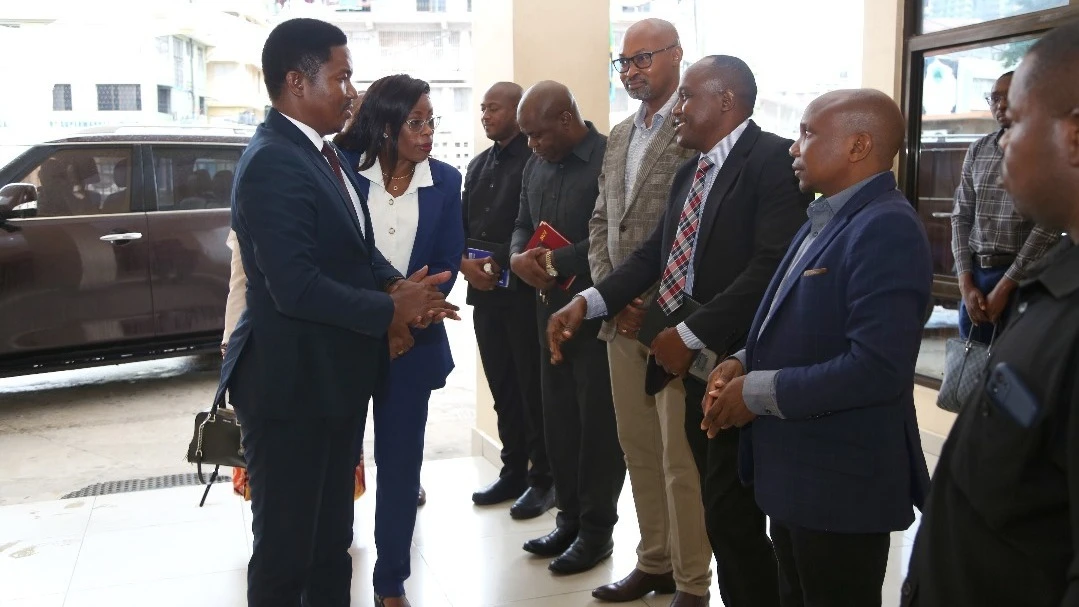 Industry and Trade minister Dr Selemani Jafo (L) speaks with College of Business Education officials including rector Prof Edda Lwoga (next to him) shortly after the minister arrived at the college in Dar es Salaam yesterday for a routine tour. 