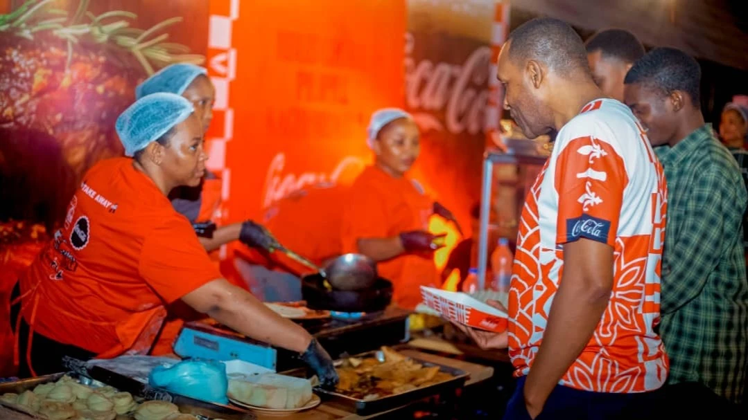 Coca-Cola Kwanza Ltd Director of Logistics Haji Ally Mzee gets served for a meal during the launch of Coca-Cola Food Festival . The event was held over the weekend in Dar es Salaam.