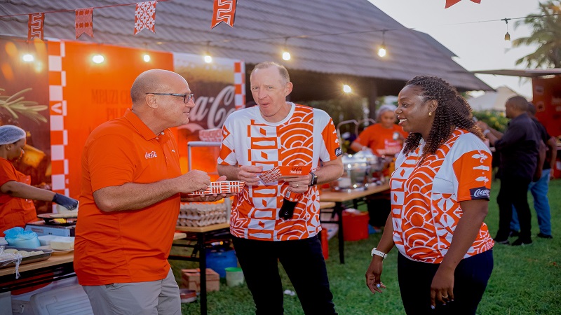 Coca-Cola Kwanza managing director Jonathan Jooste (C) shares a light moment with members of the Coca-Cola Tanzania staff at the launch of a Coca-Cola Food Festival meant as a tribute to Tanzania’s diverse and rich culinary heritage. 