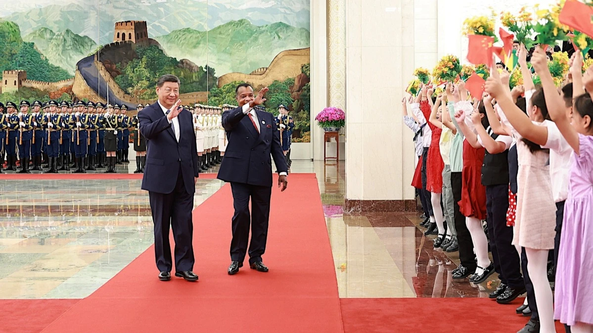 Chinese President Xi Jinping and President of the Republic of Congo Denis Sassou Nguesso, who is in Beijing for the 2024 Summit of the Forum on China-Africa Cooperation and a state visit, greet children holding bouquets and national flags.