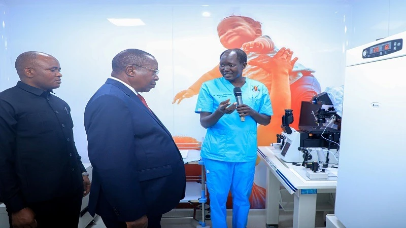 Dr Chuor de Garang Alier, an embryologist with the Dr Samia Suluhu Hassan Implantation Centre at the Muhimbili National Hospital, briefs Vice President Dr Philip Mpango on in vitro fertilisation. It was shortly after the VP inaugurated the facility in Dar