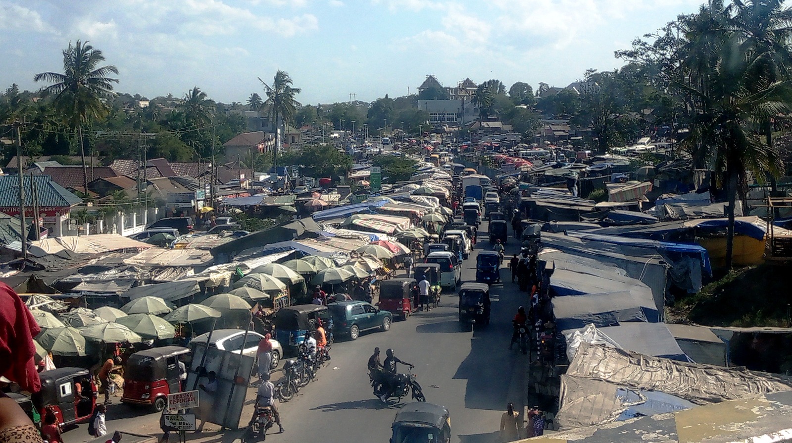 The especially creative or innovative could easily concur in calling this ‘Umbrella Roadside Open Market’ – for, indeed, that is precisely the role this particular ‘backyard’ of Dar es Salaam’s Mbezi Mwisho commuter bus stand 