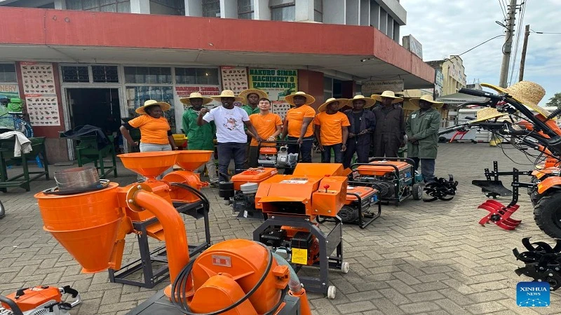 Dylan Zhang (5th L), sales manager at Sincerity International Group, poses for a group photo with local farmers at a general machine dealer promotion event in Nakuru county, Kenya.