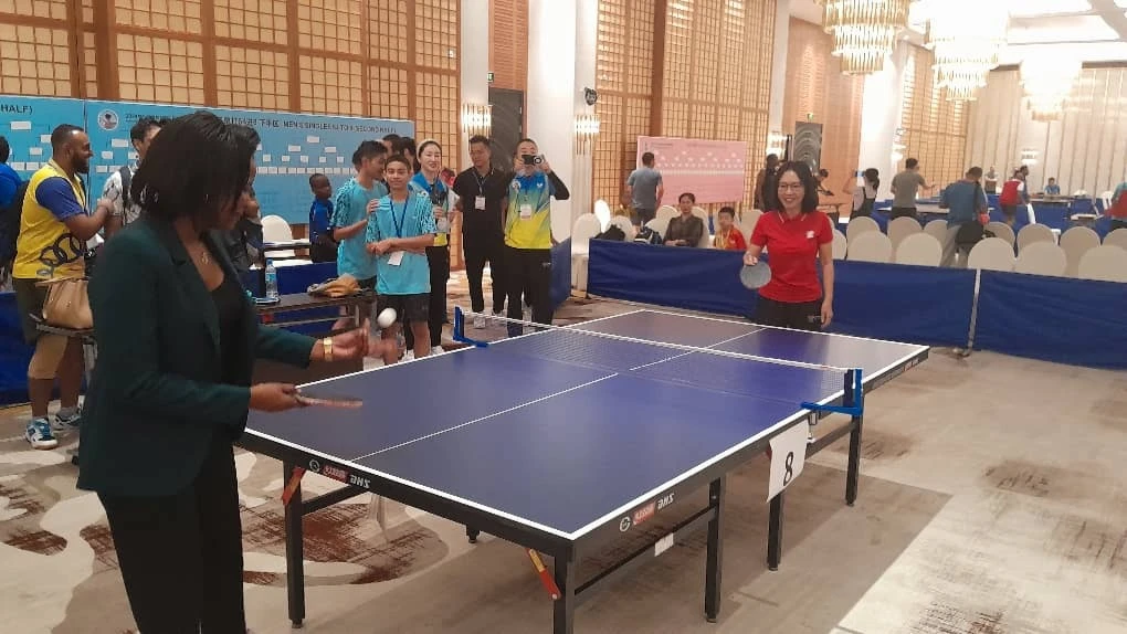 Chen Mingjian, Chinese ambassador to Tanzania (right in red) pictured together with Neema Msitha, Secretary General of the National Sports Council (NSC), playing table tennis shortly after the launch of 2024 China-Tanzania table tennis tournament .