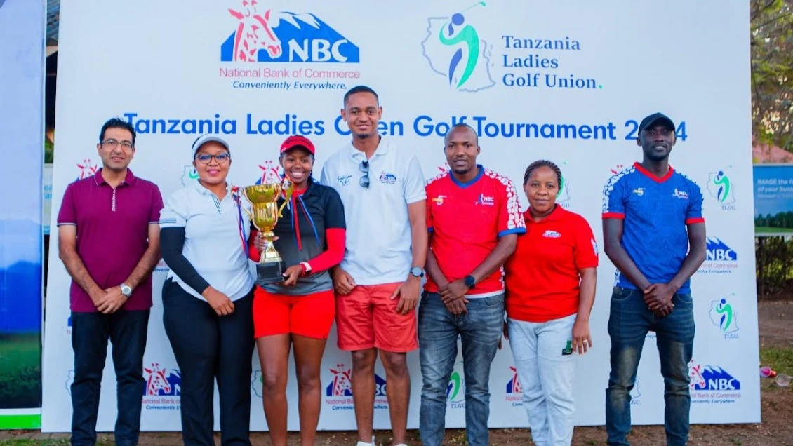 The President of the Tanzania Ladies Golf Union (TLGU), Queen Siraki (2nd L), and NBC Bank Corporate Relations Manager, Gerald Tarimo (C), in a group photo with some of the participants and winners of the just concluded Tanza Ladies Open Golf Tournament