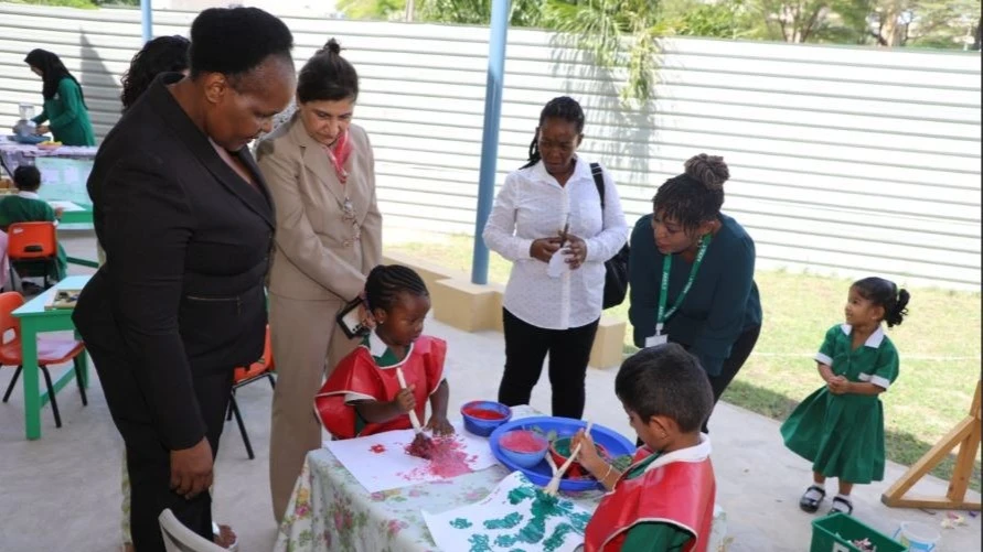 Dr. Aneth Komba, the Director General of the Tanzania Institute of Education (TET) (L), Dr. Shelina Walli, the CEO of Aga Khan Education Services (AKES) Tanzania(next tpo  her), watching pupils showcasing their painting activities during a familiarization