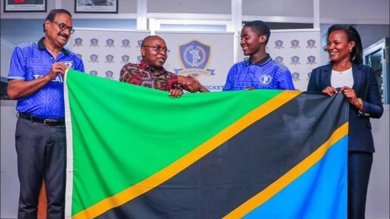 
Minister for Culture, Arts, and Sports Damas Ndumbaro (2nd L) hands over the national flag to Tanzania's U-19 women's cricket team assistant skipper Agnes Joseph (2nd R), when he bade the squad farewell in Dar es Salaam last week. 