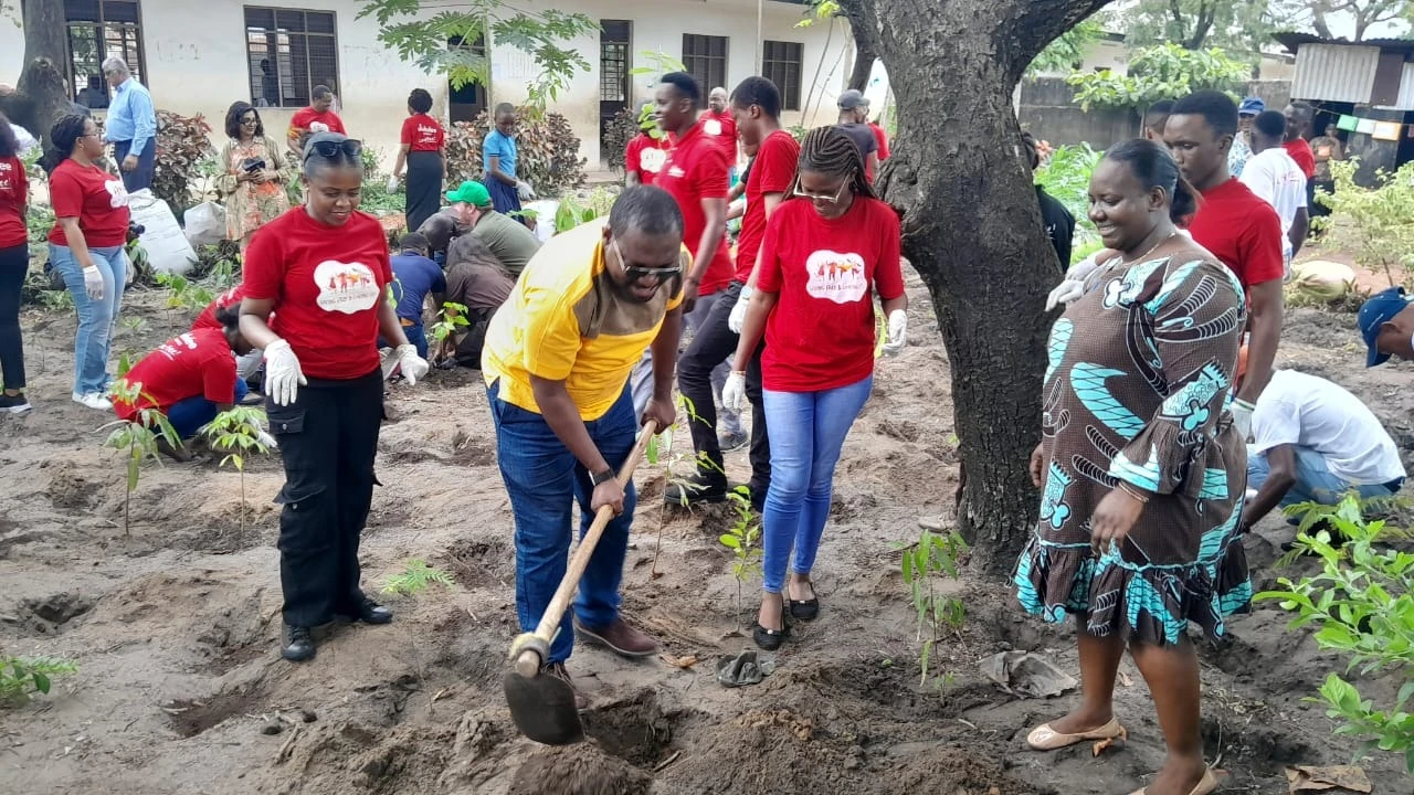 Temeke district commissioner Sixtus Mapunda, along with Jubilee Life Insurance and Agha Khan Foundation staff during the 200 tree planting session held at Madenge Primary School in Temeke Dar es Salaam.