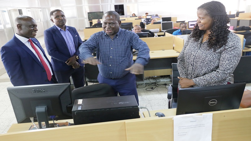 The Guardian managing editor briefs the Ecobank Tanzania MD on pre-press operations in the TGL newsroom. Right is Nipashe newspaper news editor Salome Kitomari.