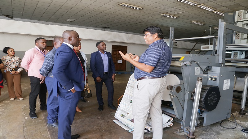 The TGL printing manager explains to Dr Asiedu how newspapers are printed. 