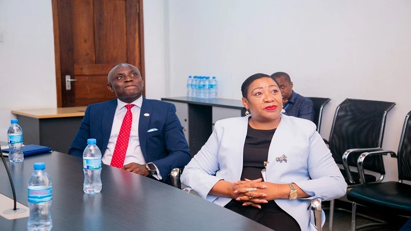 Ecobank managing director Dr Charles Asiedu (L) follows the presentation by The Guardian marketing manager Weapon Mwanjombe (not in picture) during his tour at the company’s premises in Mikocheni, Dar es Salaam