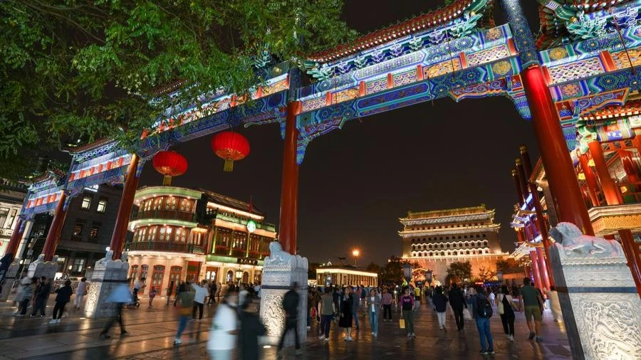 Tourists visit the Qianmen Street and the Zhengyang Gate arrow tower in Beijing, capital of China, Sept. 26, 2024.