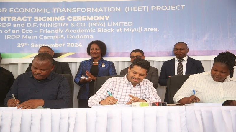 
Rector of IRDP, Prof. Hozen Mayaya (L), and Director of D.F Ministry & Co (1974) Limited, Bhavesh Mistry (center), sign the contract for the construction of the eco-friendly academic block at IRDP’s main campus in Miyuji, Dodoma.