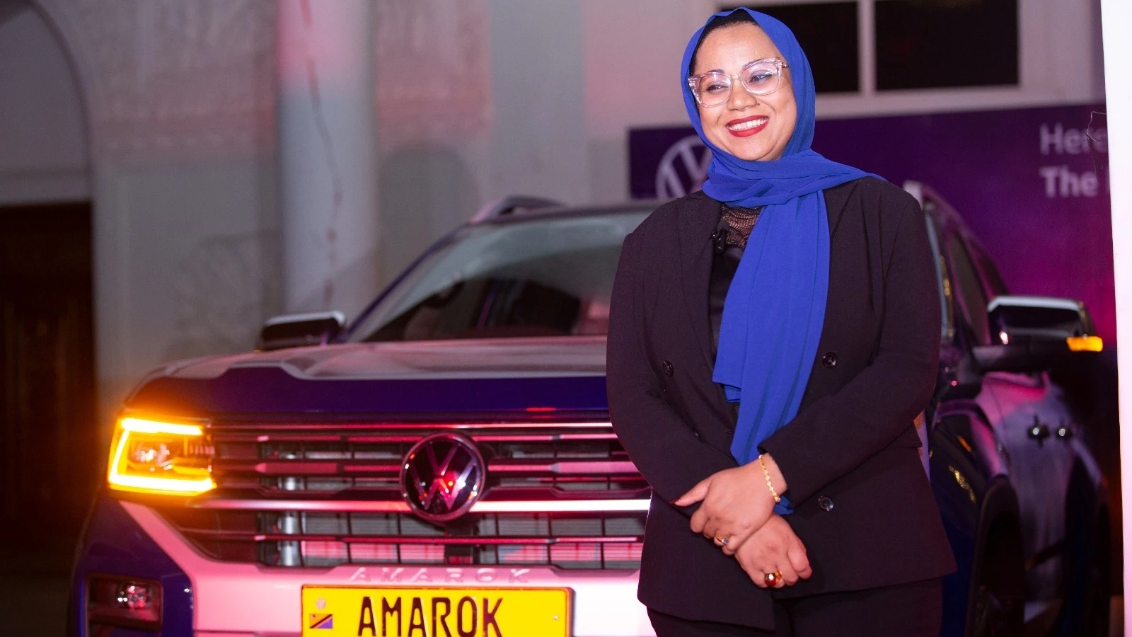 Tharaia Ahmed, the Director of Sales and Marketing at CFAO Mobility Tanzania poses for a photo in front of the newly unveiled Volkswagen Amarok during the launch event held at Warehouse in Dar es Salaam. 