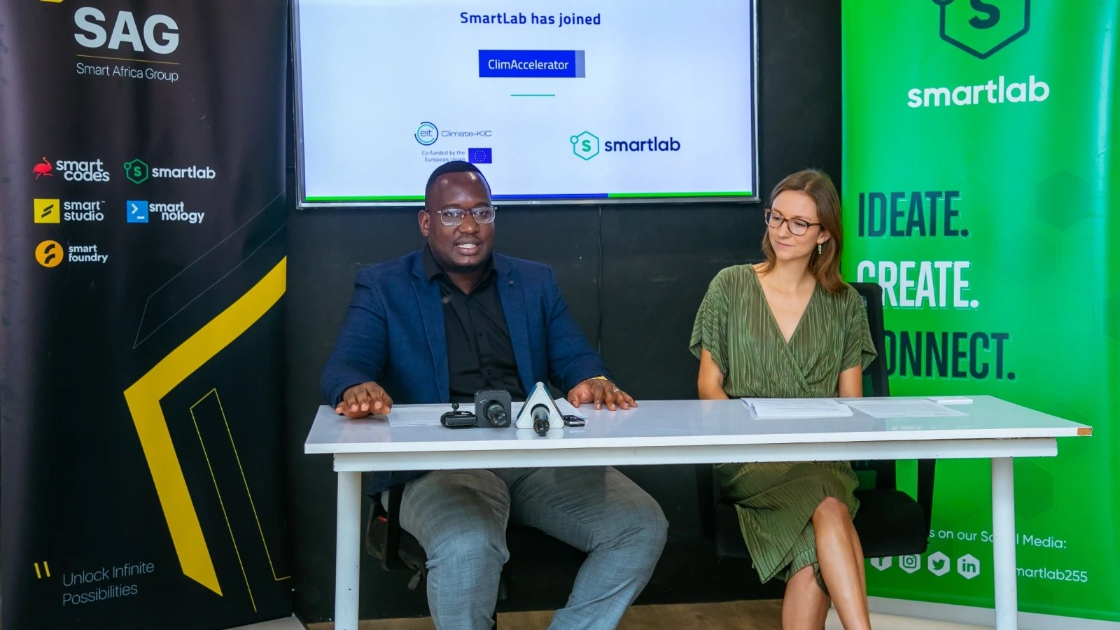 Larry Ayo, business director at SmartLab (L) addresses journalists in Dar es Salaam yesterday during the launch of the second edition of the Adaptation and Resilience-ClimAccelerator programme, seated next is Sophie White