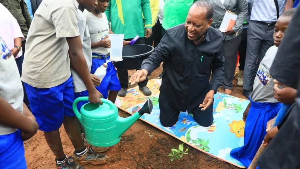 
WAZIRI wa Katiba na Sheria, Prof. Palamagamba Kabudi akipanda miti katika Shule hiyo.