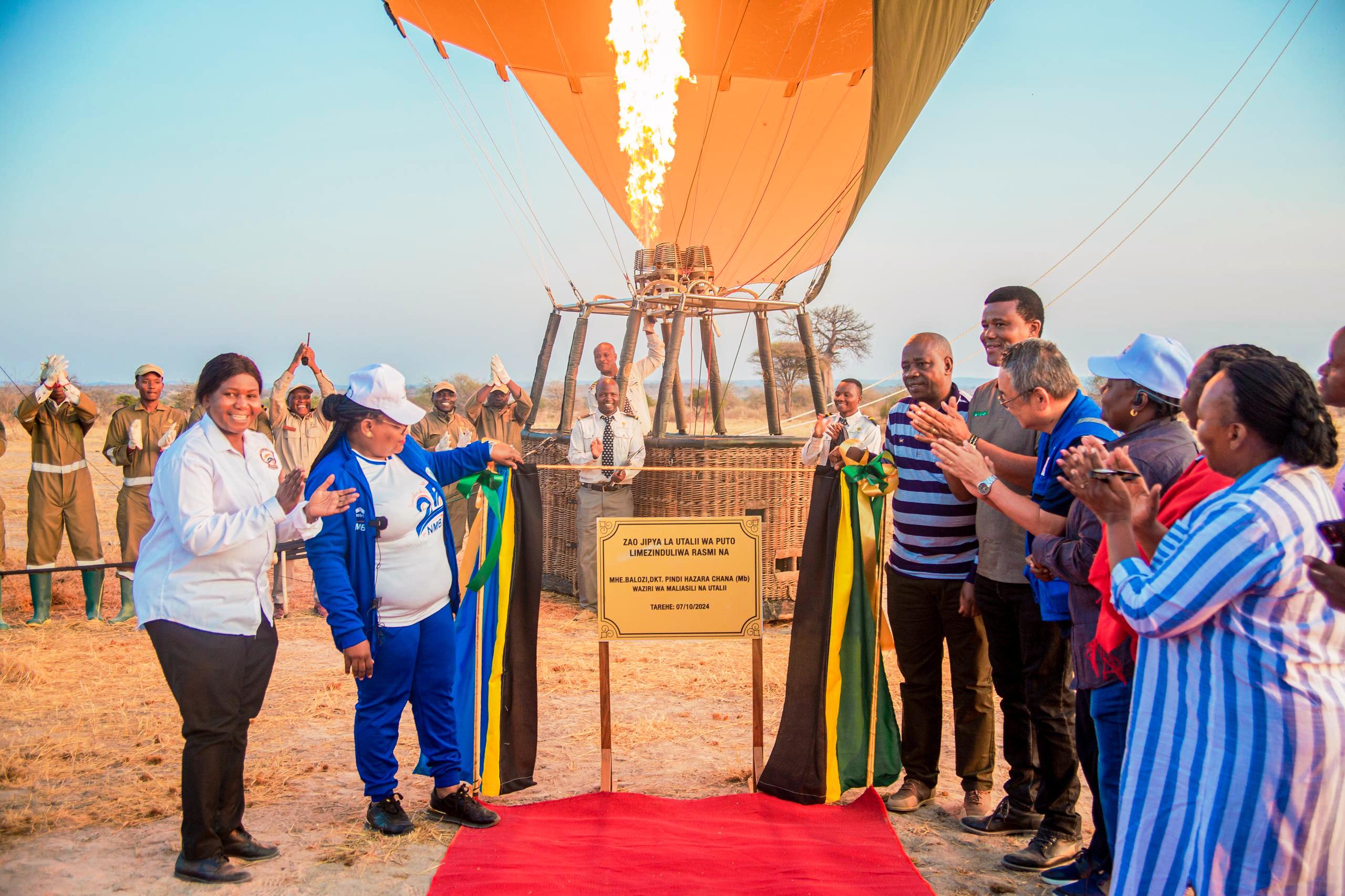 Natural Resources and Tourism minister Dr Pindi Chana (2nd-L), along with various leaders from the ministry graces the launch of a parachute tourism initiative in the Ruaha National Park yesterday in marking the wildlife sanctuary’s 60th anniversary. 