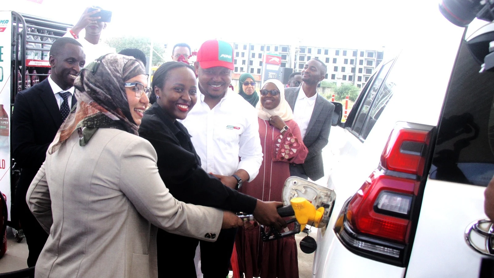 
Kigamboni District Head, Halima Bulembo (centre) filling up a car to mark the opening of the Puma Energy Tanzania petrol station and additional services in Dege Street, Somangila Ward, Dar es Salaam. Joining him on the left is the company's CEO, Fatma