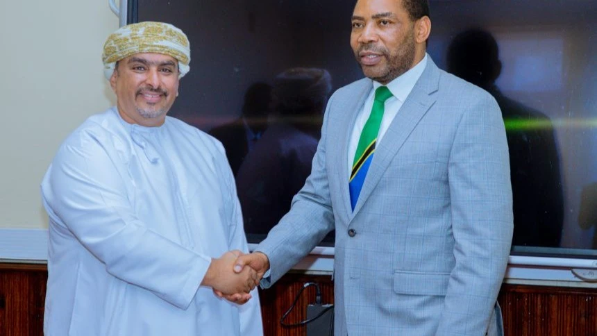  Finance Minister Dr Mwigulu Nchemba (R)  and Omani Ambassador to Tanzania, Saud Al-Shidhani. (L)