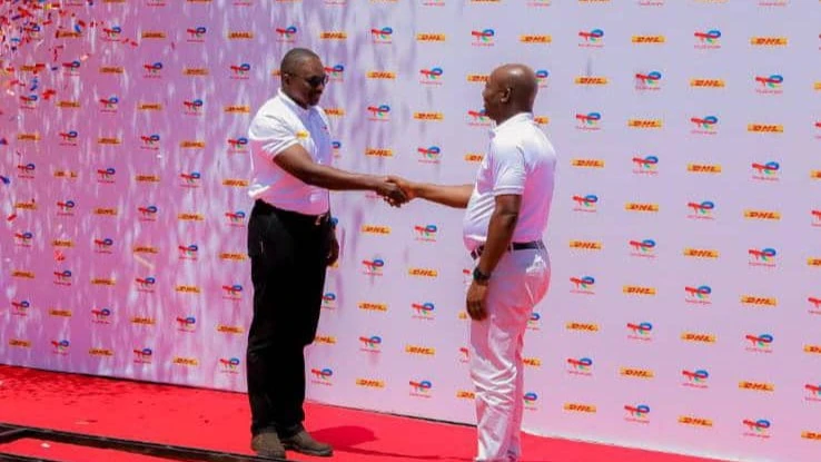 The DHL Tanzania Managing Director, Humphrey Pule ( left ) and the TotalEnergies Network Director Abdul Rahim Siddique shaking hands when the two companies launched partnership in Dar es Salaam on Friday.