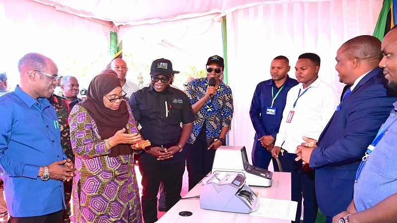 President Samia Suluhu Hassan is briefed on gold sales in Geita town yesterday when gracing the climax of the 7th Geita Mining and Technology Exhibition. 