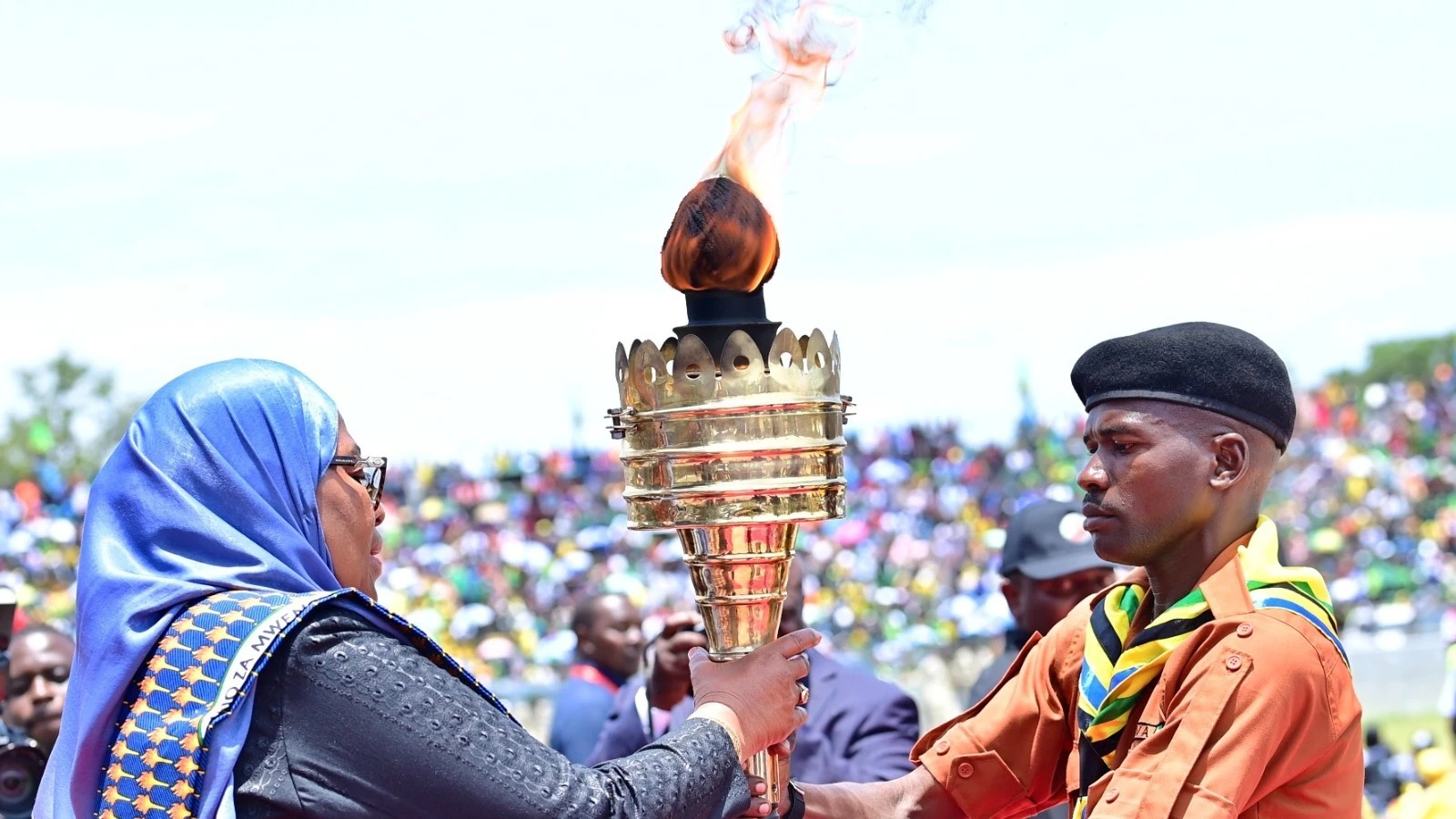 President Samia Suluhu Hassan pictured at Mwanza city’s CCM Kirumba Stadium yesterday receiving the Uhuru Torch from the leader of this year’s edition of the ‘cross-country’ Uhuru Torch Race, Godfrey Mzava. It was the climax of the annual event. 